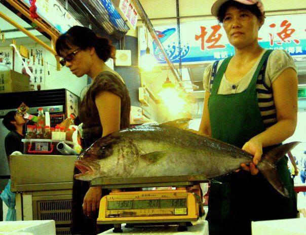 Weighing fish at the fish market.