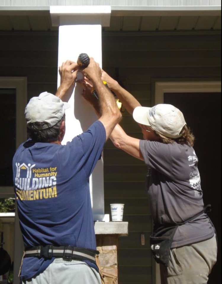 Mom and Dad, working to build someone else a home on a Habitat for Humanity trip. 