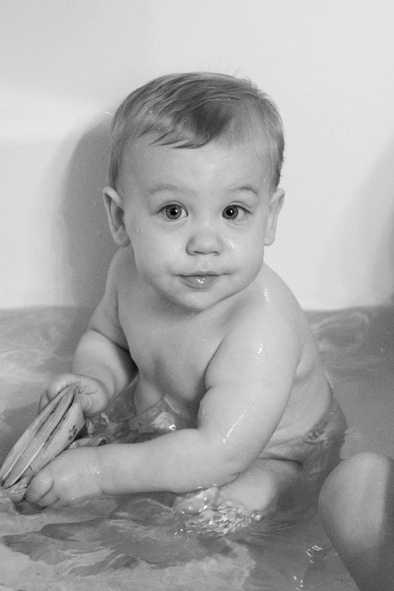 baby boy in tub black and white photo