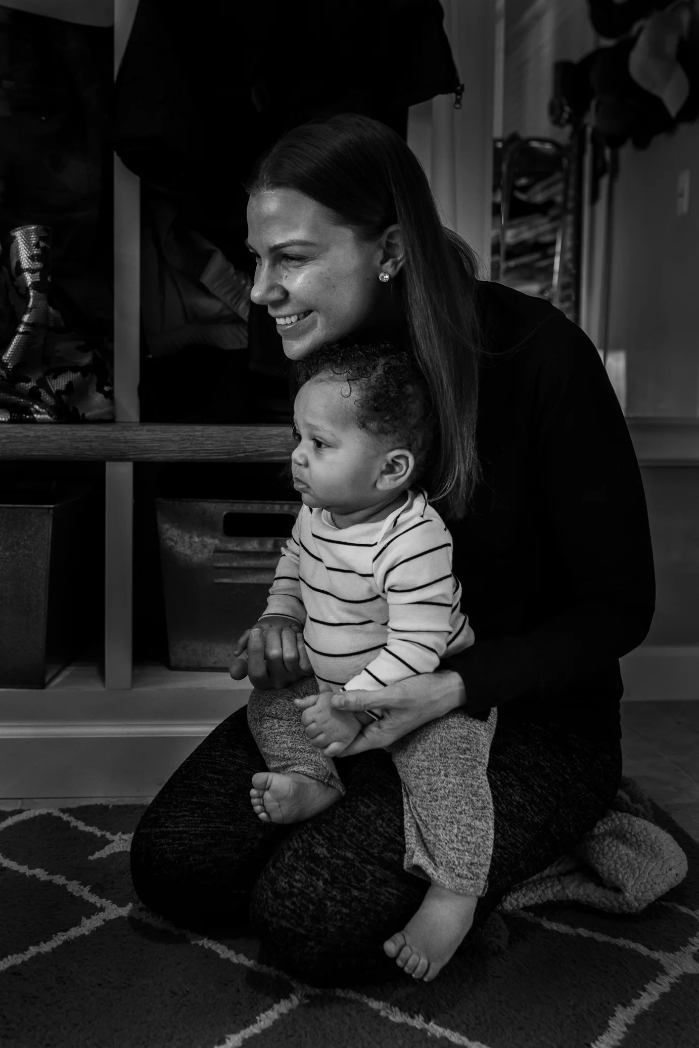 Mom holding her son on her lap and smiling