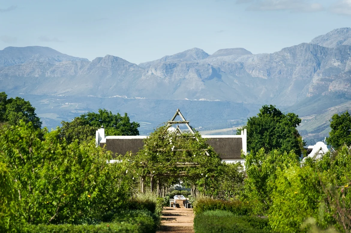 Farmhouse with mountains as backdrop