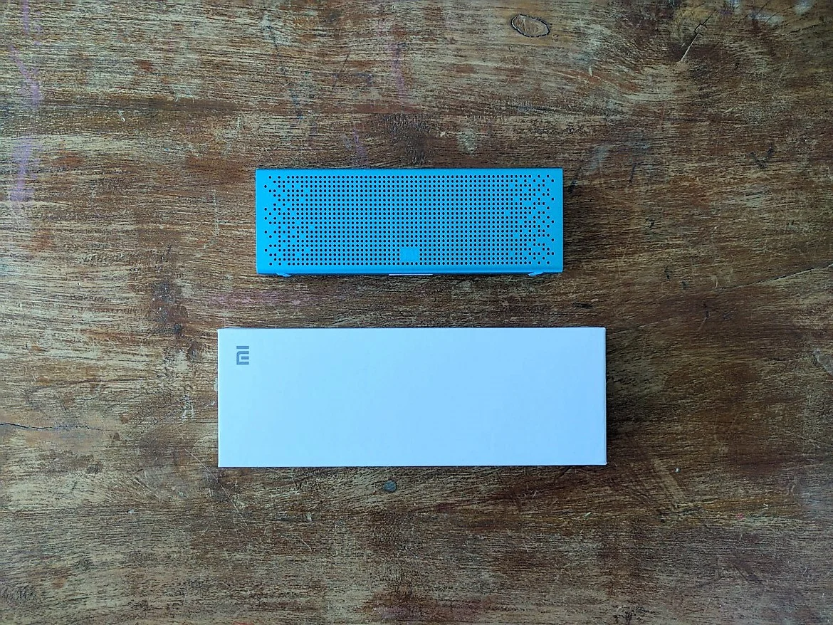 Xiaomi V2 Stereo with case on wooden table