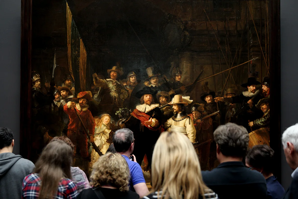 People staring at a painting in Rijksmuseum, Amsterdam