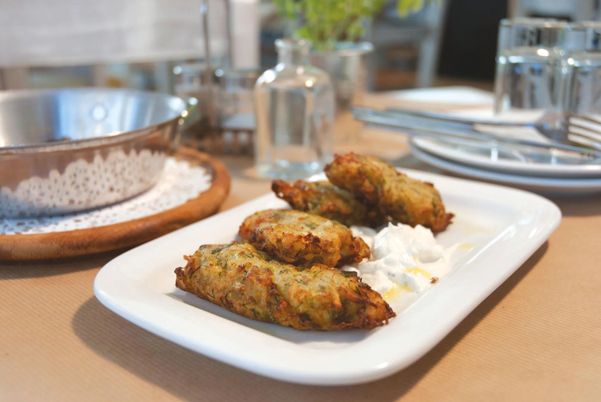 Crispy kolokythokeftedes , served with home-made tzatziki sauce.