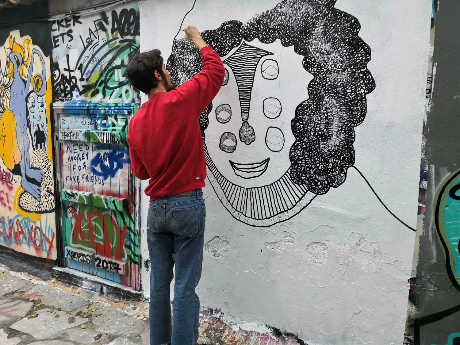 Artist while creating a graffiti in Athens