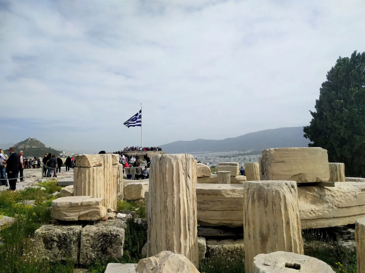 Greek flag and ruins at the Acropolis