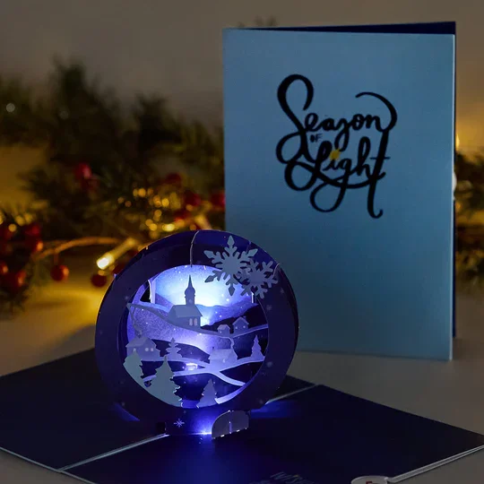 LP5795_Season_of_Light_Winter_Village_Light-Up_Pop-Up_Card_Lifestyle_060141a1-4084-4cc3-81f3-b04cfd38d5fb.webp