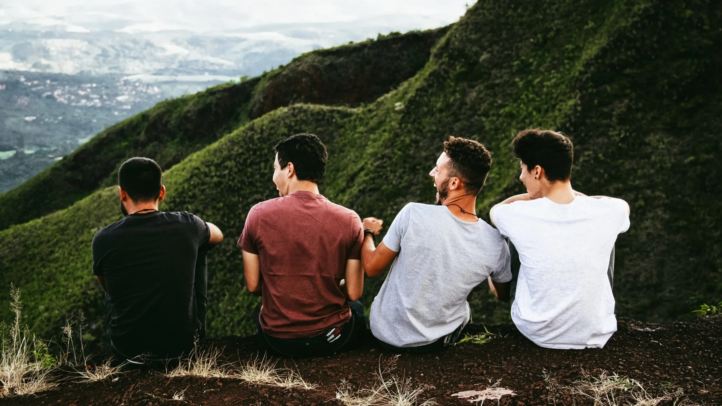 A group of friends sitting together on a hillside