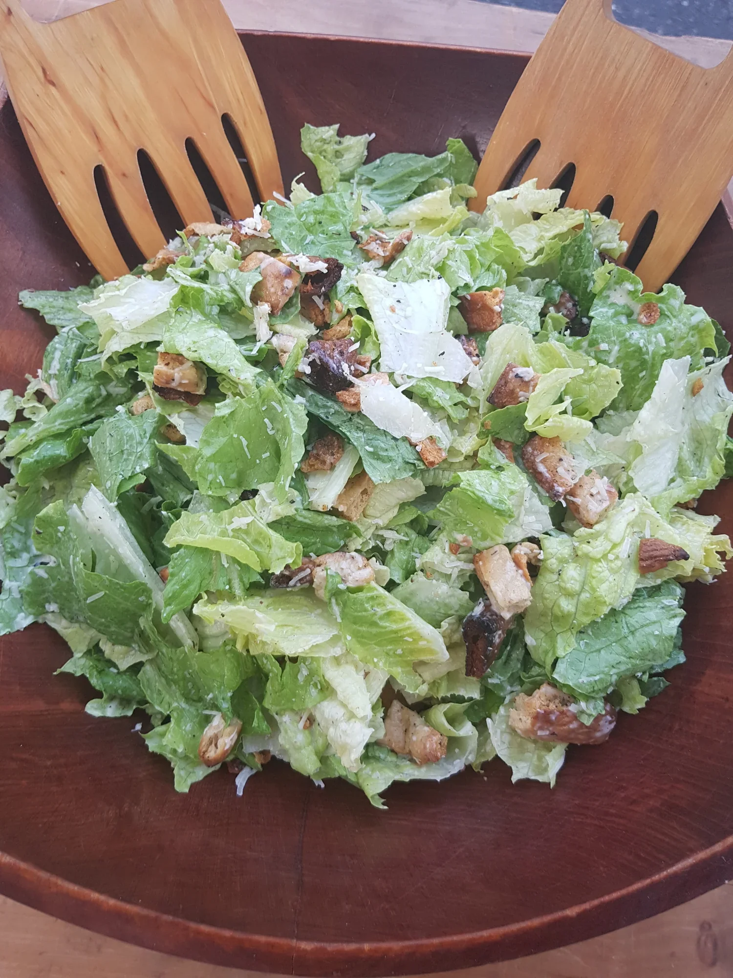 Caesar salad with croutons and shaved Parmigiano Reggiano