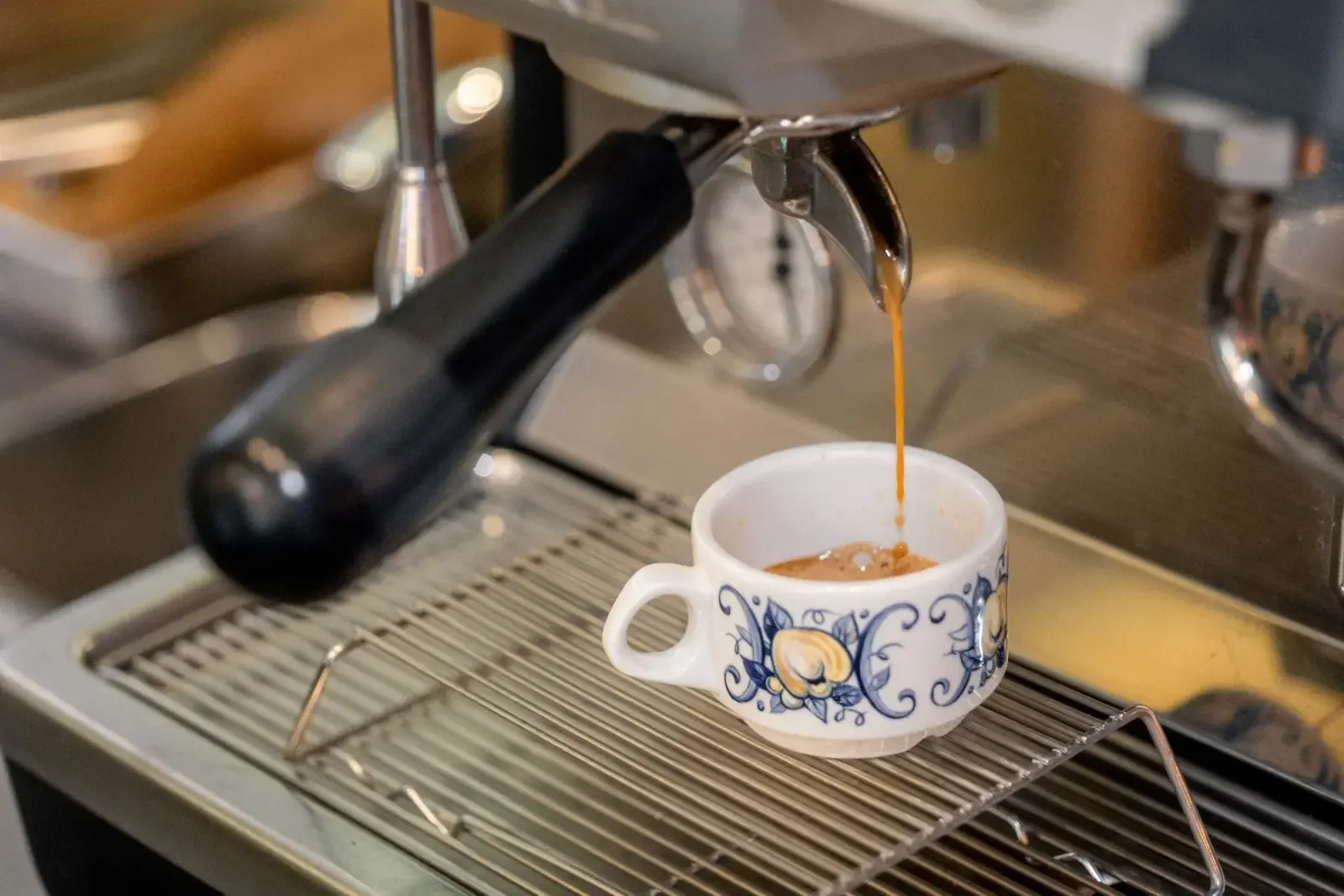 Espresso pouring into a patterned cup at Night Kitchen.