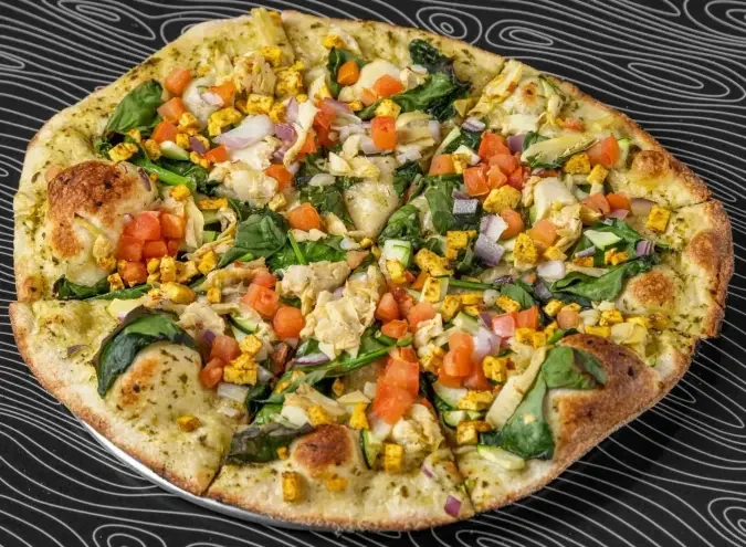 Rock Lobster pizza with colourful vegetables on a pesto base at Night Kitchen.