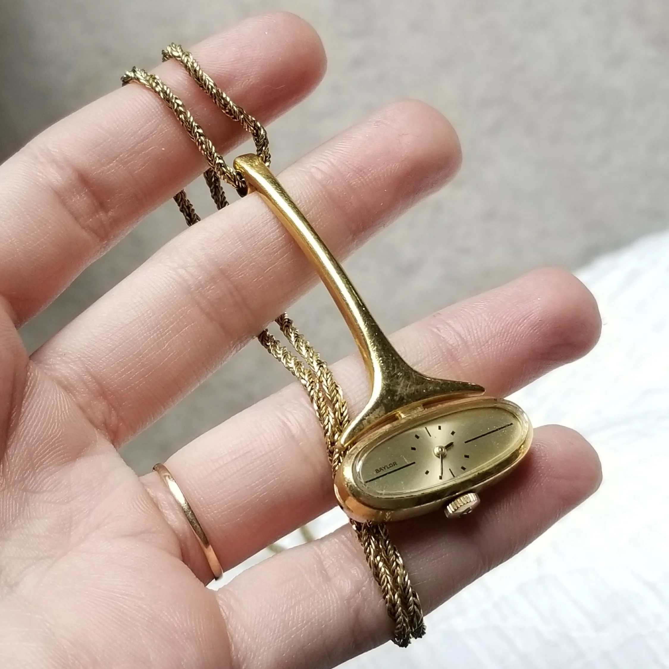 The gold necklace watch.