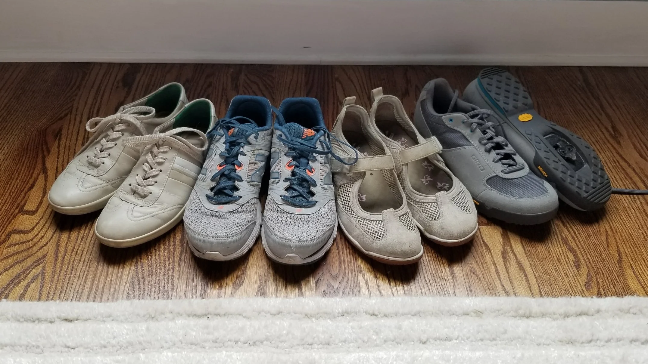 L to R: Ecco sneakers, workout shoes, summer biking shoes, bike cleats.