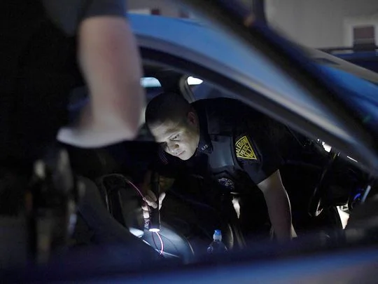 Haledon police officers search a car after detecting an odor of marijuana. Photo: Danielle Parhizkaran/Northjersey.com