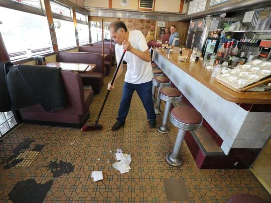 Salvador Suarez cleans up after the final lunchtime at the Egg Platter Diner in Paterson. Photo: Chris Pedota/NorthJersey.com
