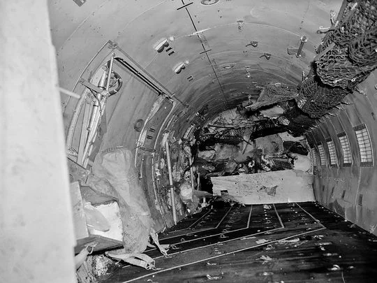 An investigating soldier, far end center, looks up through the window into the cabin of the plane. Virtually every seat in the cabin was ripped loose during the crash. Photo: associated press