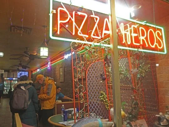 The weekly ritual reaches its midpoint at Brother Bruno's, a pizza restaurant near the Port Jervis train station. The Thorpes split a pie with banana peppers before beginning the long journey home. Photo: Chris Pedota/NorthJersey.com