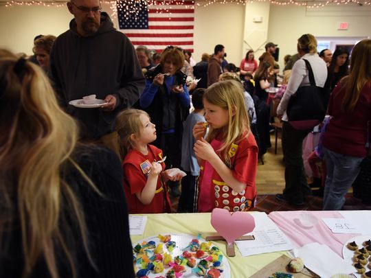Soph Kayen, 6 (center), and Lovina Crouthamel, 8, sample some baked goods. Photo: Michael Karas/Northjersey.com