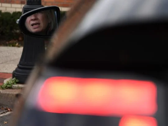 Sheila Jamroz Shilling checks her mirrors as she waits in spot No 24 to pick up her husband. Photo: Michael Karas/Staff photographer