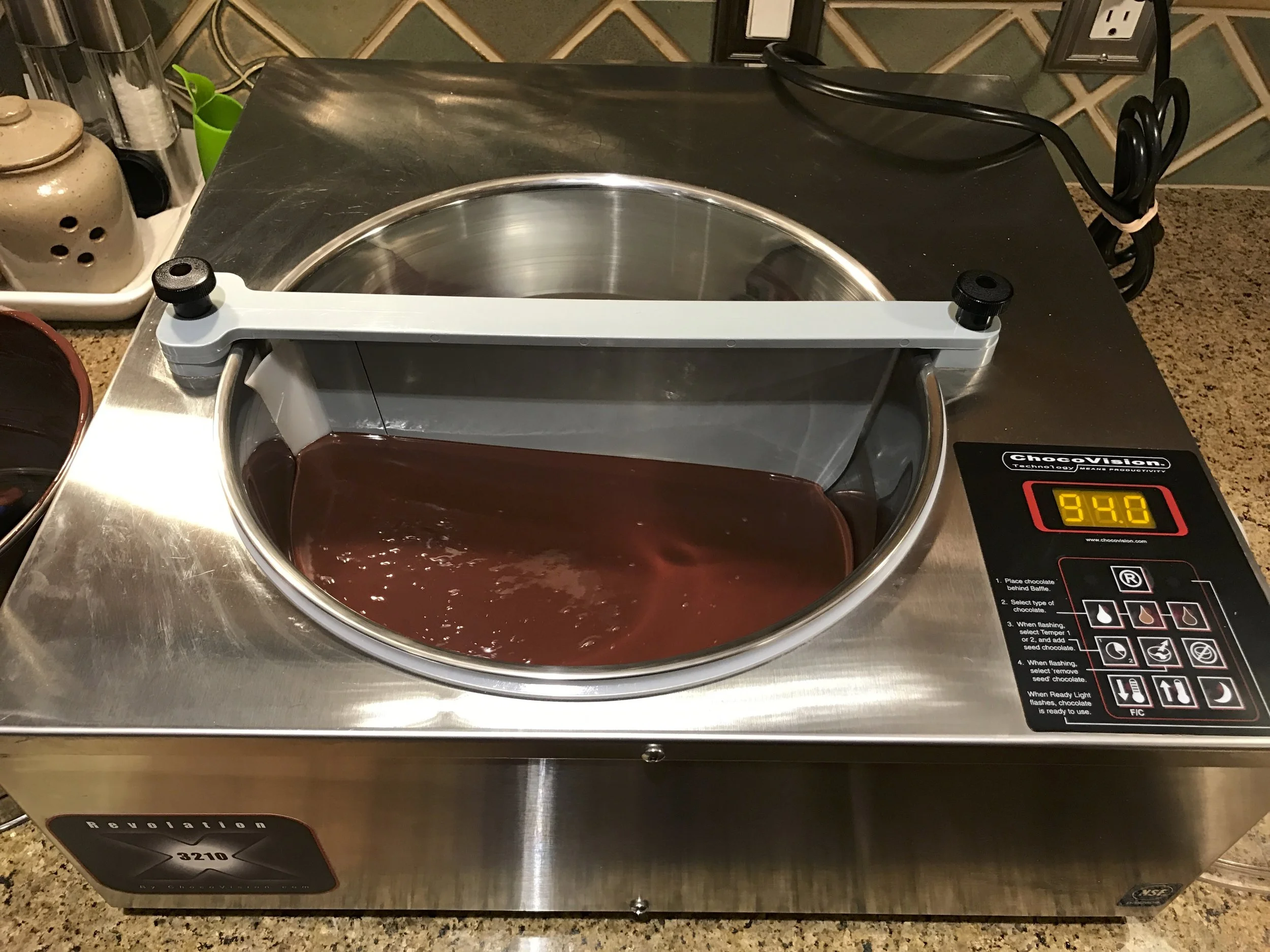 The final step in the process is tempering - a critical part of chocolate making which ensures that the chocolate you get doesn't melt in your hands, snaps when you break it and has that nice chocolate sheen for months. At this point, the chocolate is ready for molding and packaging. 
