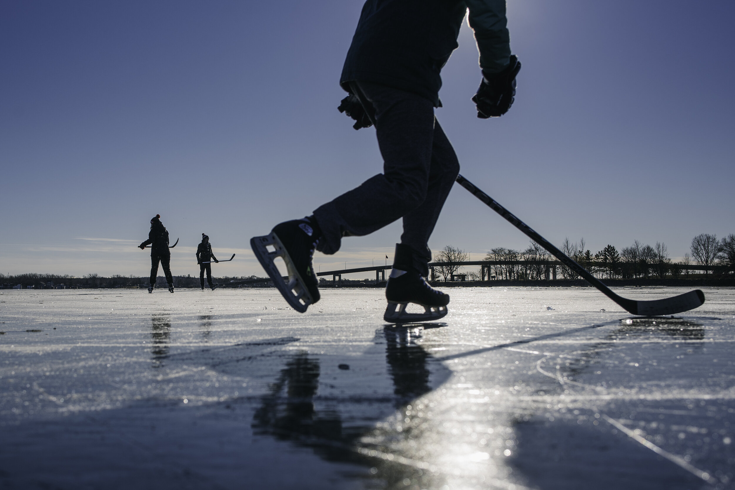  A group of friends pass a puck around the ice on Victoria Harbour in Belleville.  