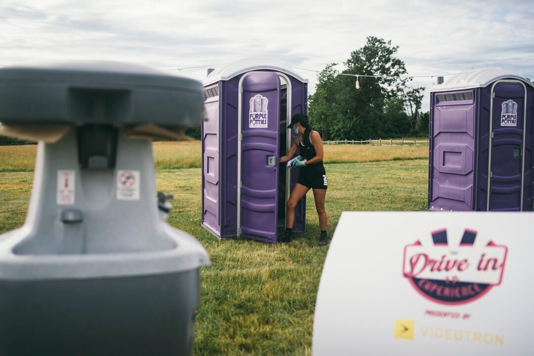   Lana Pacheco sanitizes bathroom facilities before patrons arrive at the Drive-In Experience on July 4.   