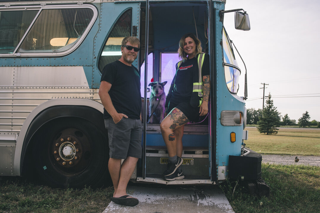   Dawn Laing, Drew Downs, and their dog, Wilma, pose in the infamous Mustang Drive-In PEC bus. The first-time drive-in owners took possession of the Mustang Drive-In PEC (Prince Edward County) in April and showed their first movie on July 2.  