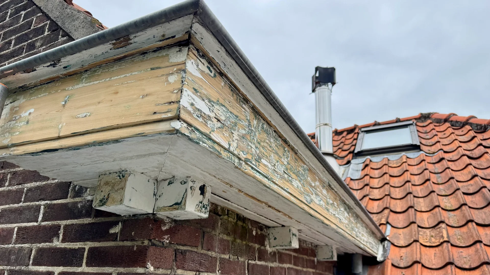 Daklijst kaalgeschuurd tijdens buitenschilderwerk in Bentveld