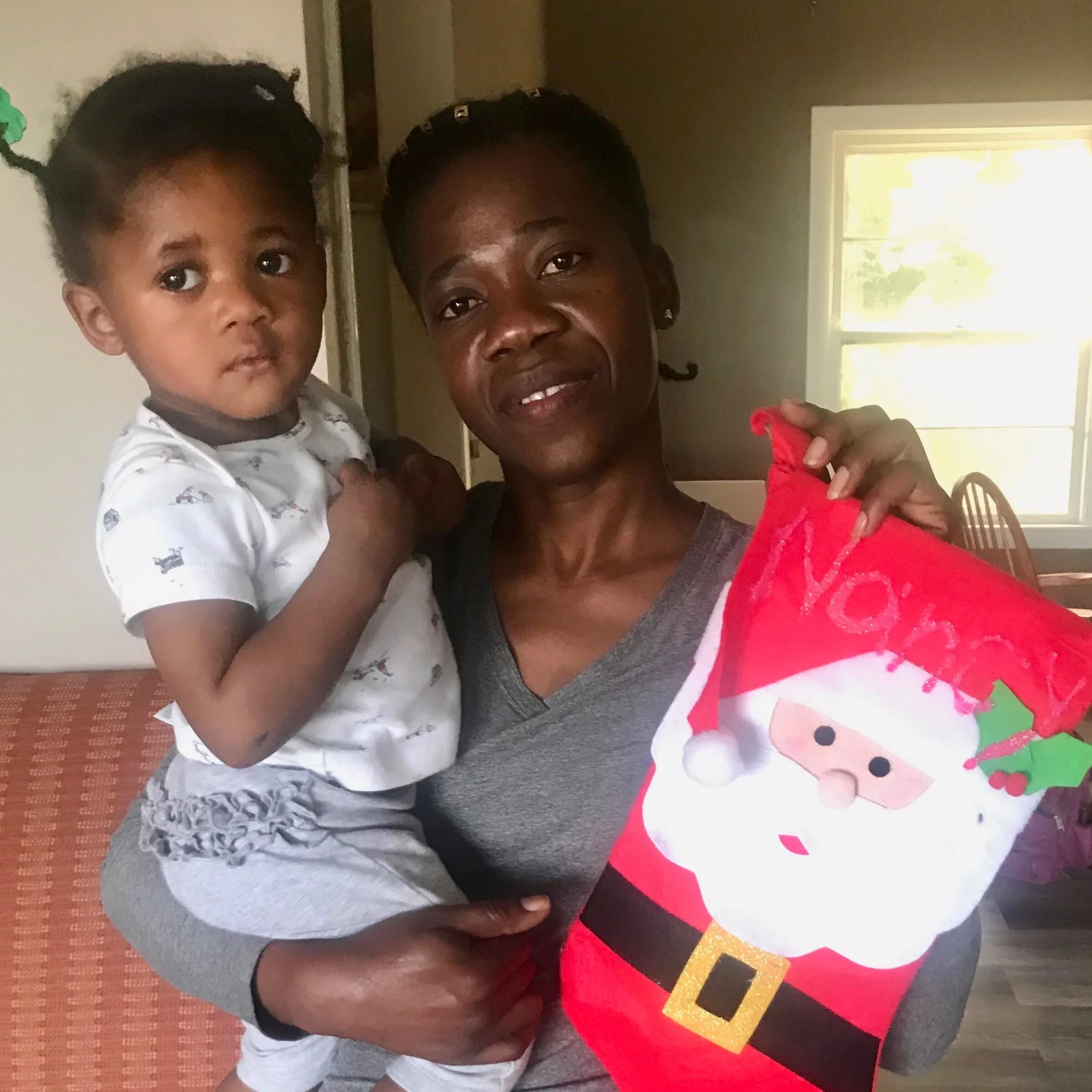 Lise Josue with her youngest daughter at her home in Jonesport, ME.
