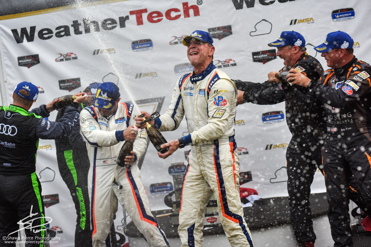  TGM Driver Hugh Plumb spraying the bubbly after winning the Michelin Pilot Challenge race. 