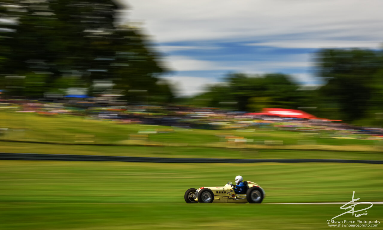  A wide-angle view of the Right Hander with Lime Rock’s signature spectator hillside in the background.  