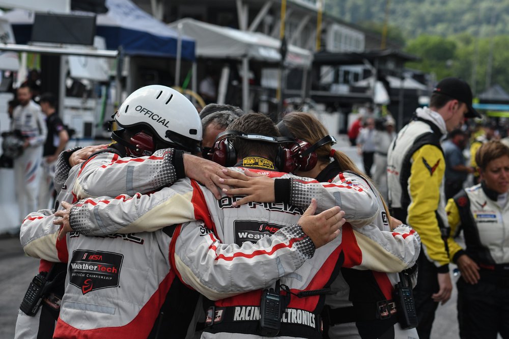  IMSA pit lane officials huddle before the start of the Northeast Grand Prix.  