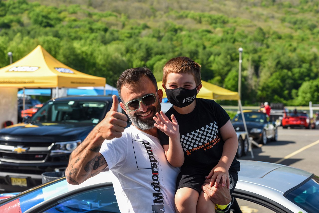  All smiles for driver and kid after Make A Wish hot laps during the Hooked on Driving event in June.  