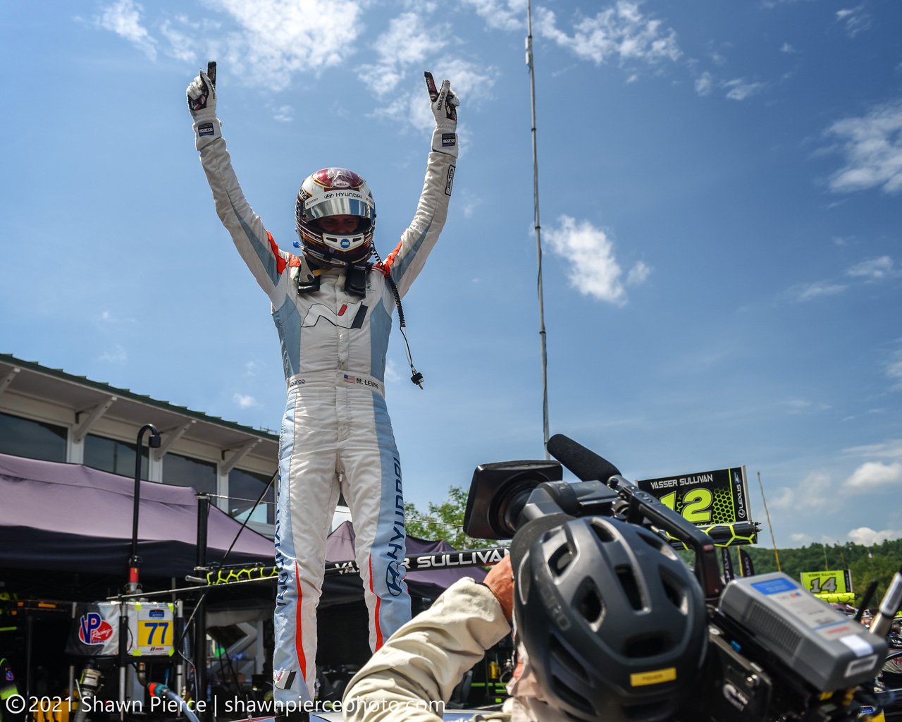  Michael Lewis on the roof of the car after bringing the win home.  