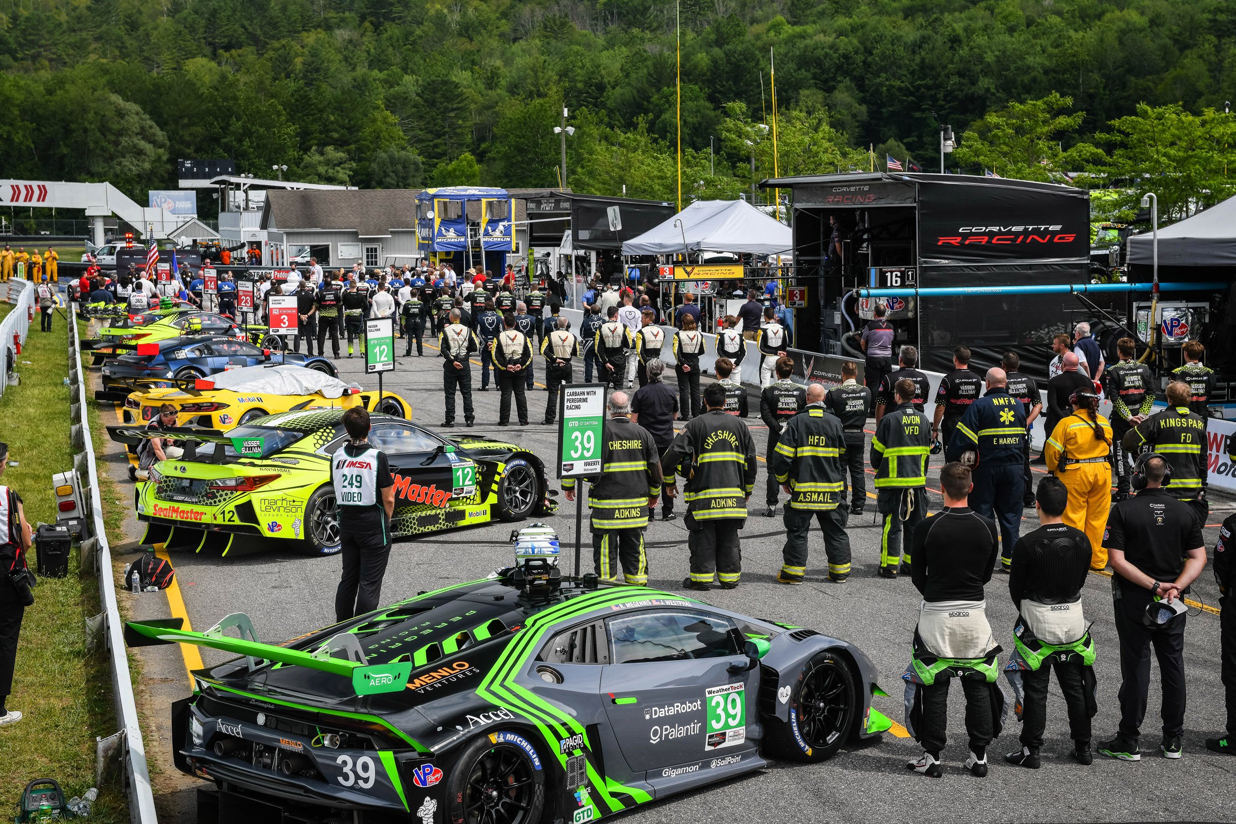 The teams lined up on pit lane during the national anthem. 
