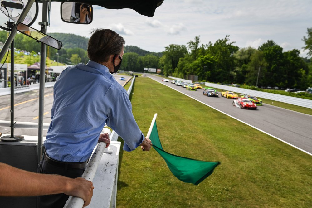US Senator Richard Blumenthal waving the green flag to start the Northeast Grand Prix. 
