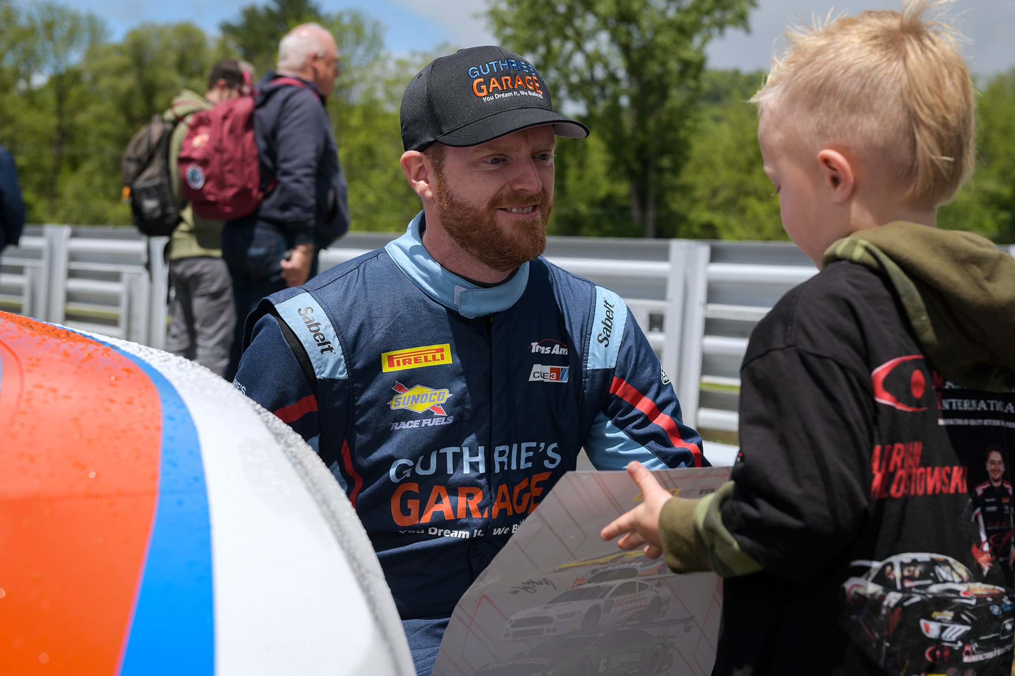  Driver Mike Skeen having a nice moment with a young fan during the Fan Walk.  