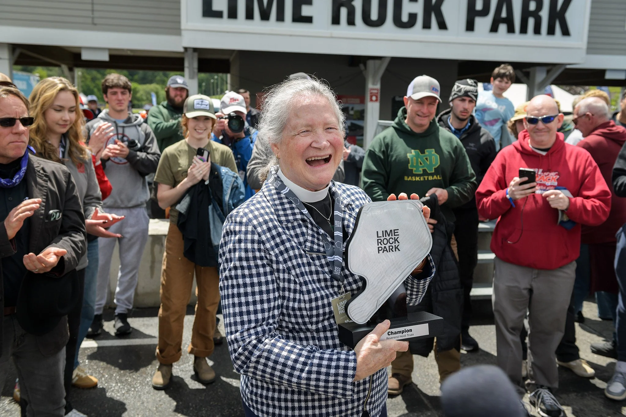  Reverend Heidi Truax, of Trinity Lime Rock Church, which is located across the street from Lime Rock Park, was gifted this commemorative trophy and a lifetime pass to congratulate her on her retirement and to thank her for her years of service. For 