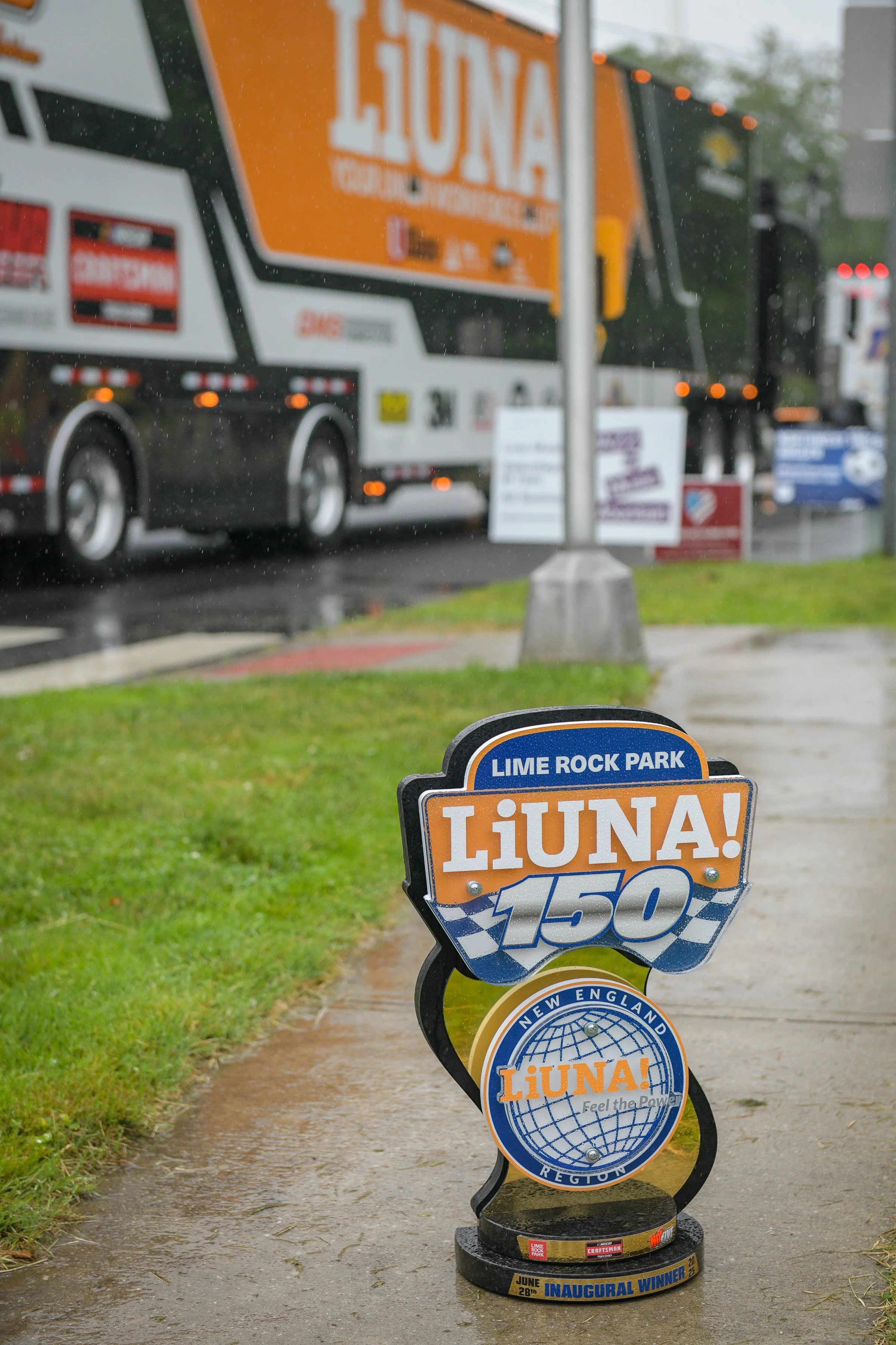  This is a photo opportunity I couldn’t pass up. The Liuna 150 trophy with the Liuna sponsored hauler passing by in the background.  