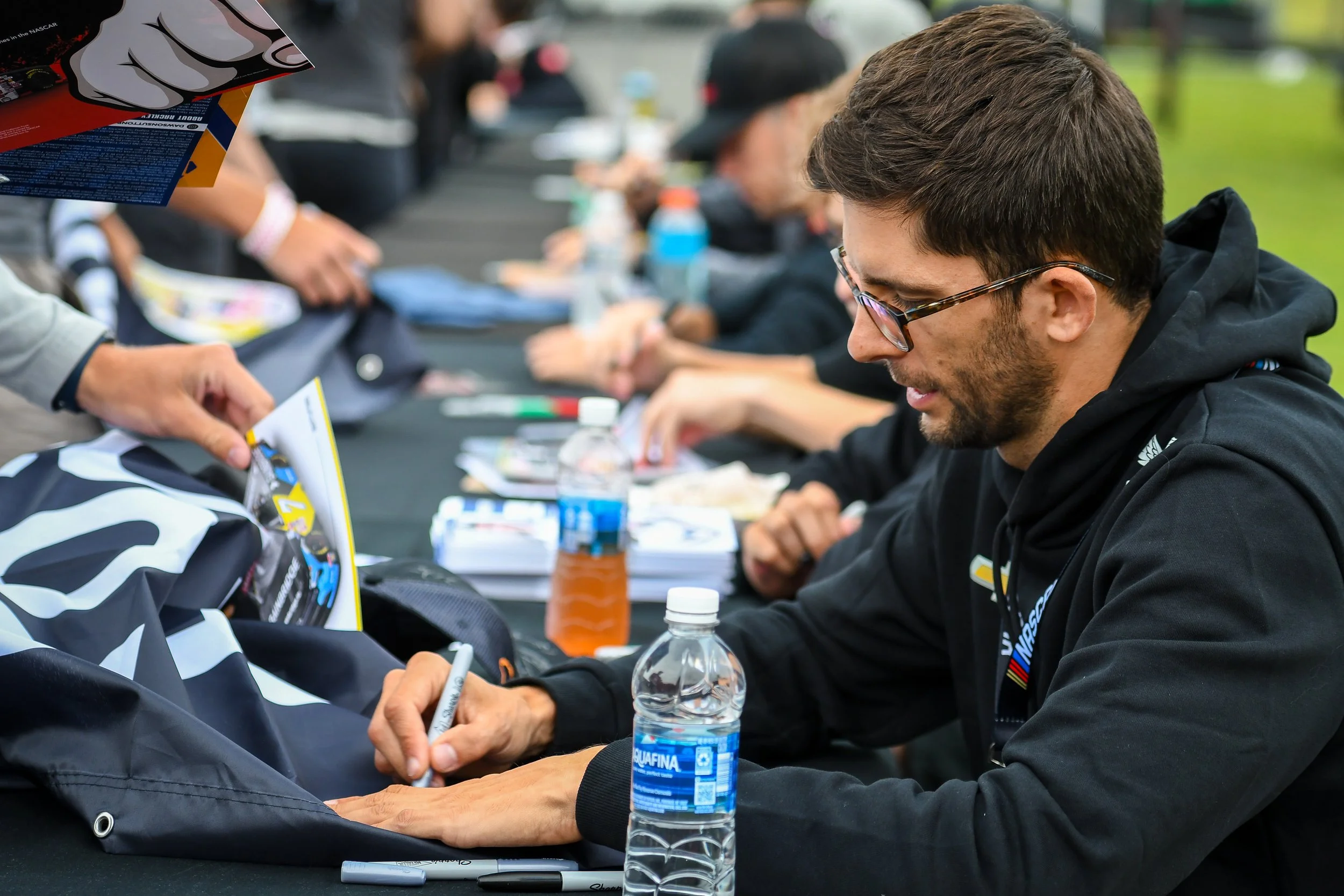  Jordan Taylor signing during Saturday’s autograph session.  