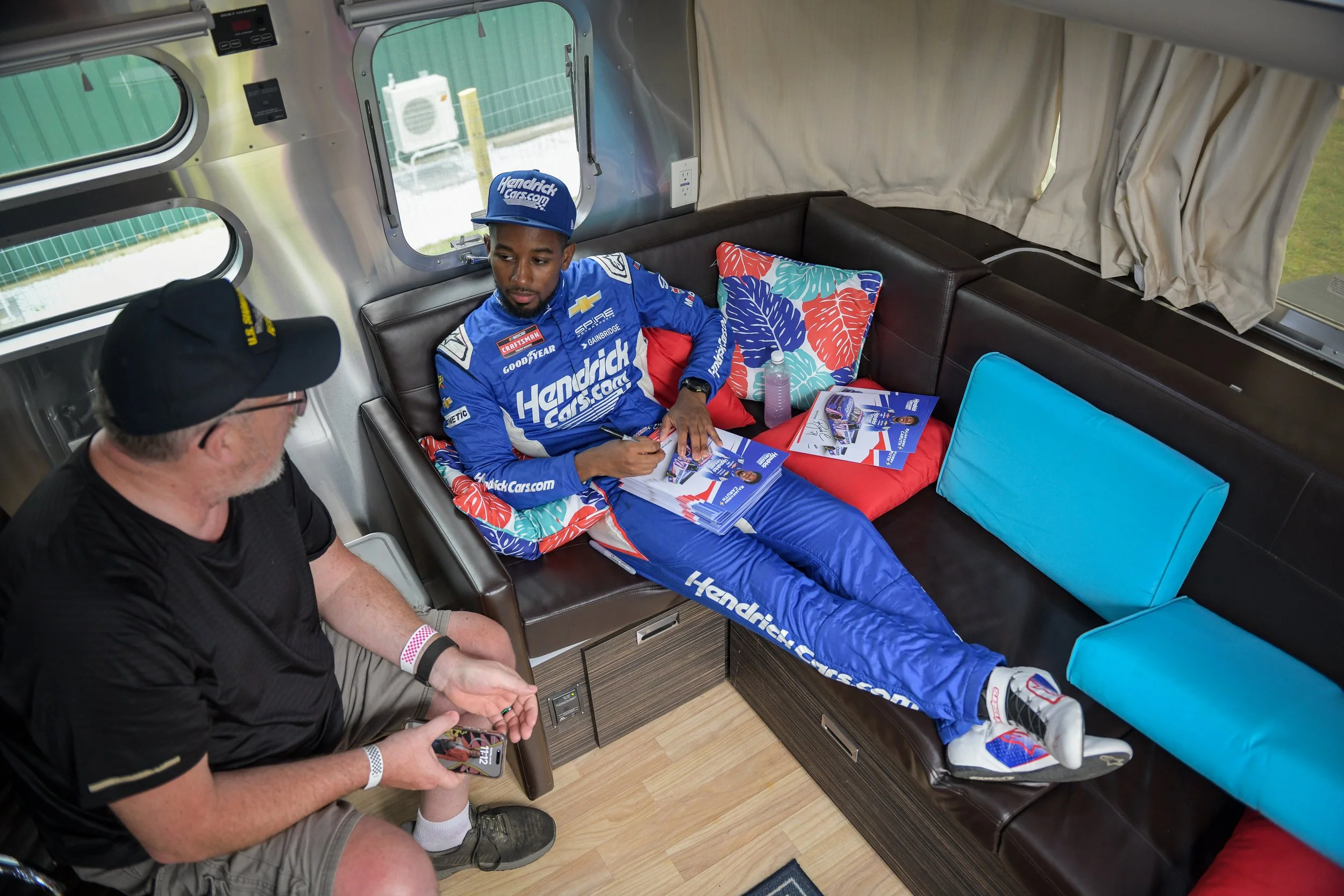  Rajah Caruth lounging and signing in one of LRP’s Airstreams during a fan meet &amp; greet.  