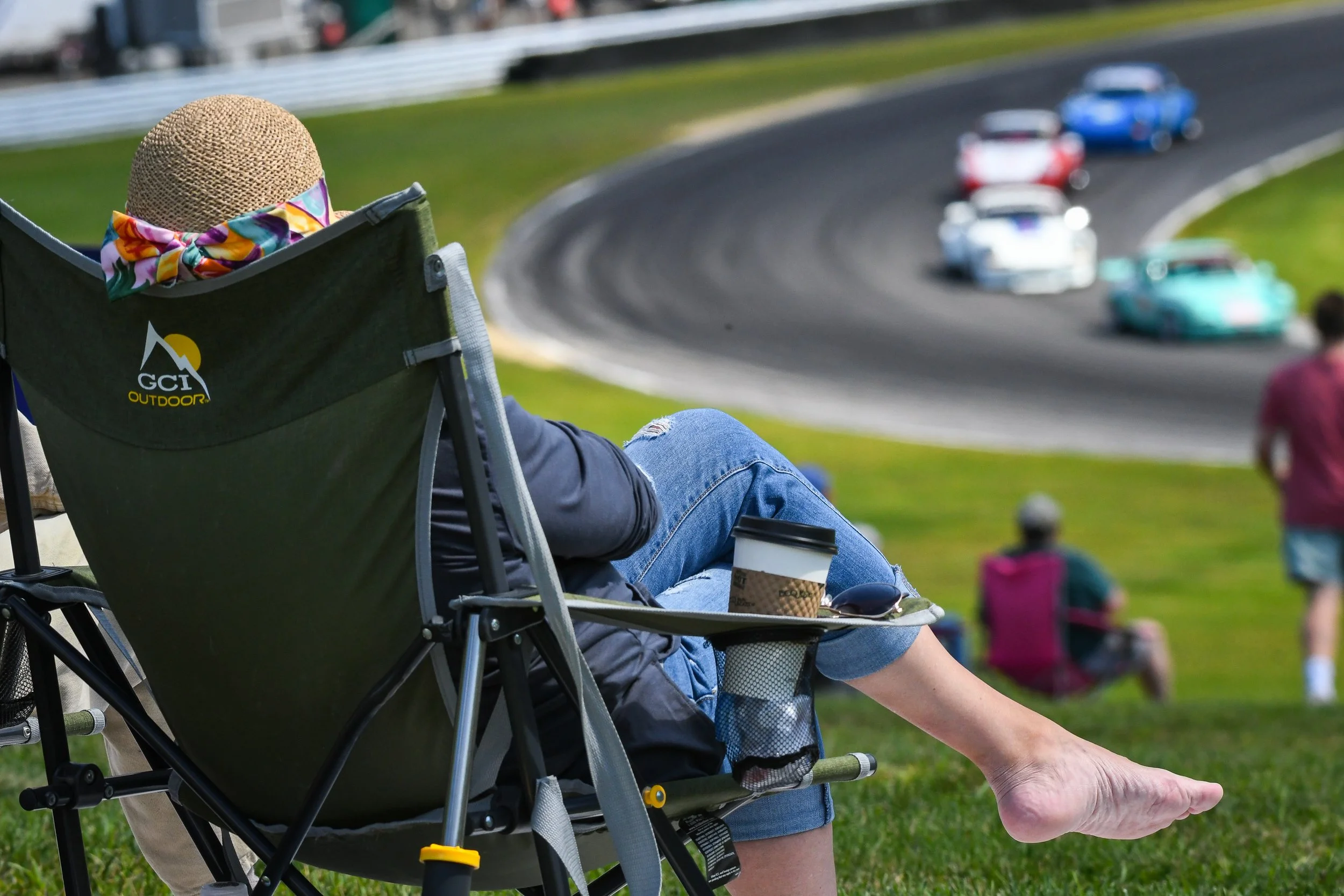  This photo sums up spectating at Lime Rock Park. Bare foot in a camping chair while the Porsche group goes through the Left Hander. What could be better?  