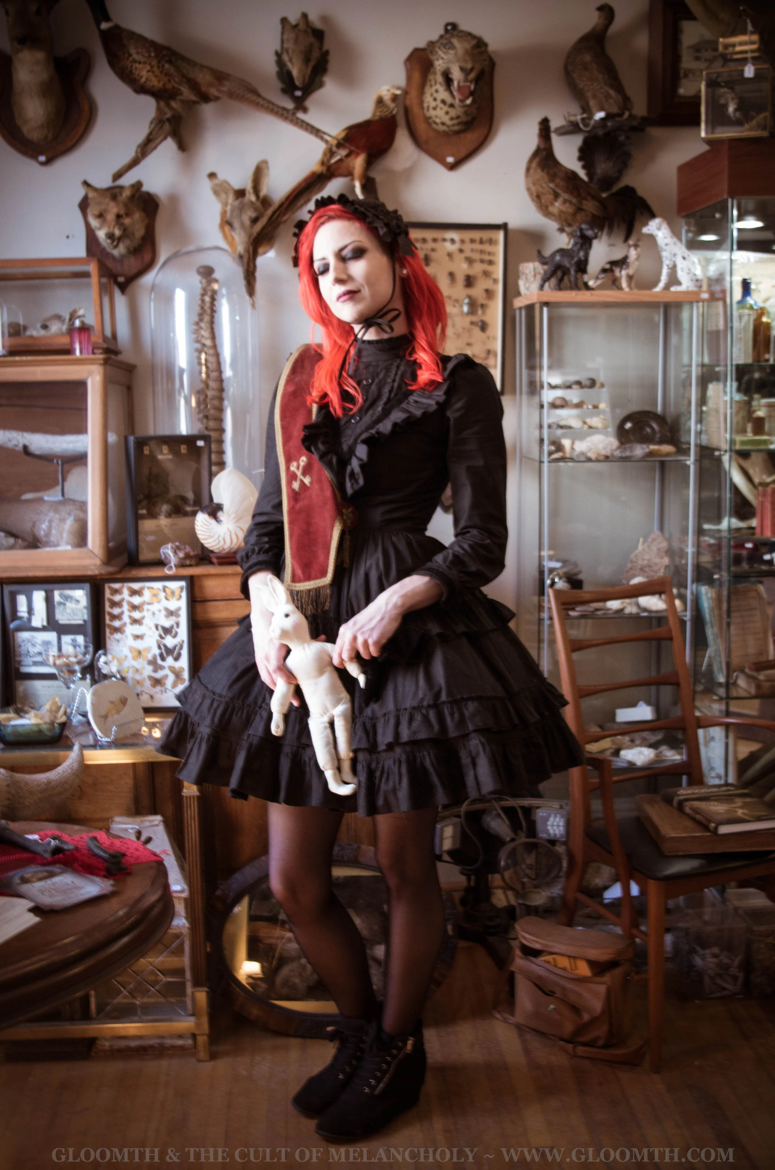gothic victorian outfit in a cluttered antique shop