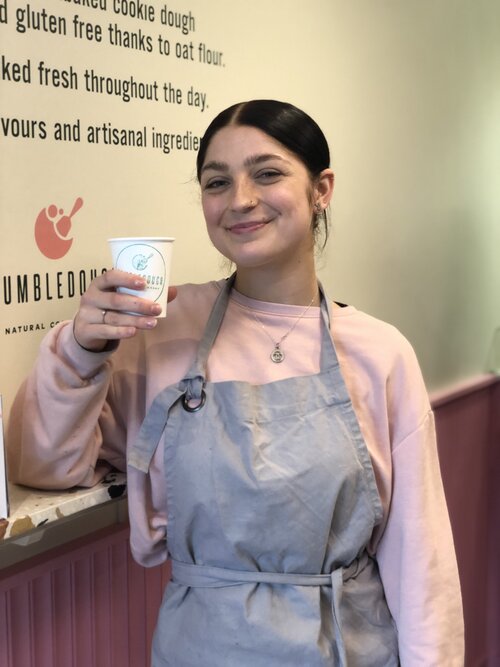 Waitress holding humble dough coffee cup