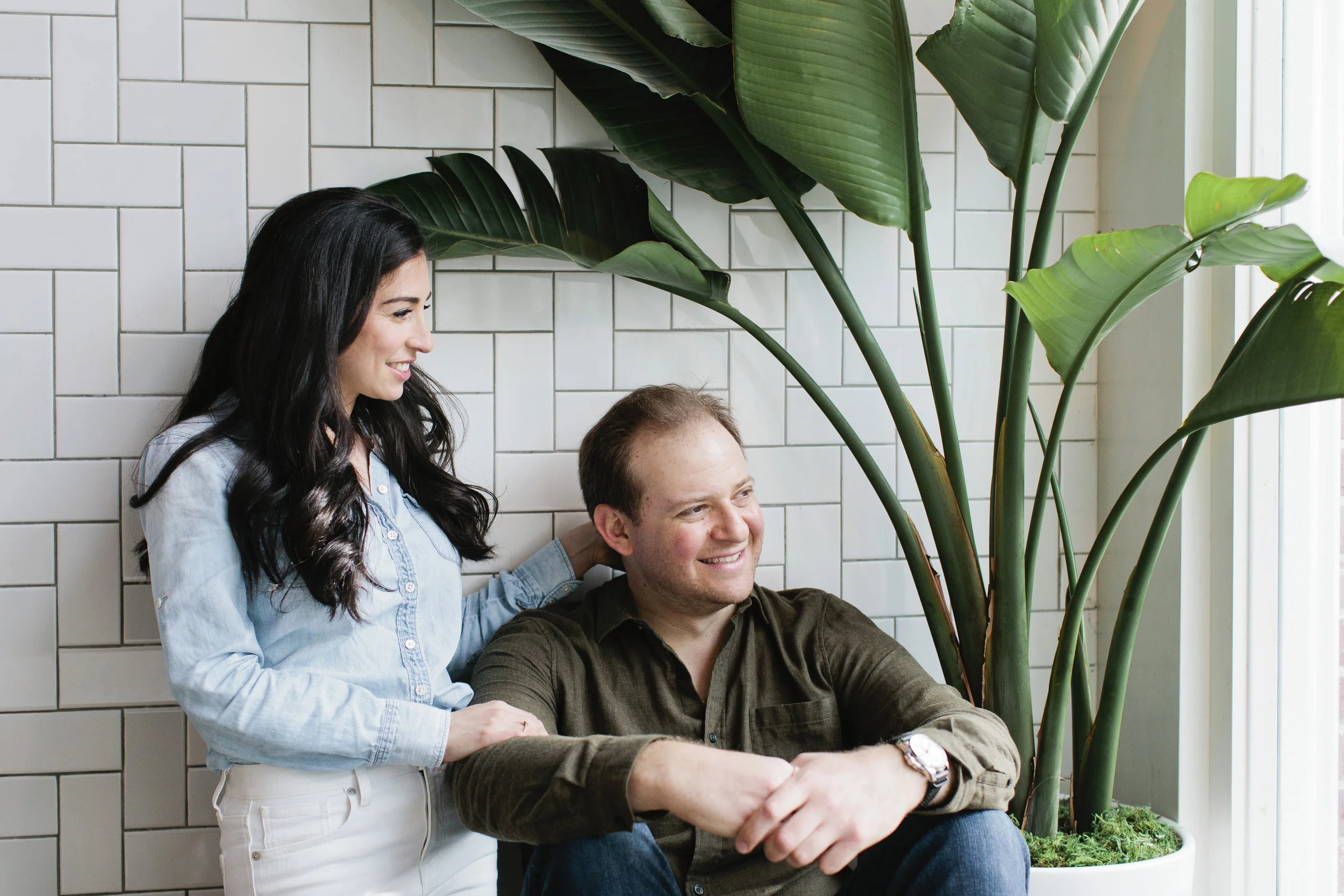 Jamie and Ryan in the window their favorite neighborhood coffee shop during their engagement session.