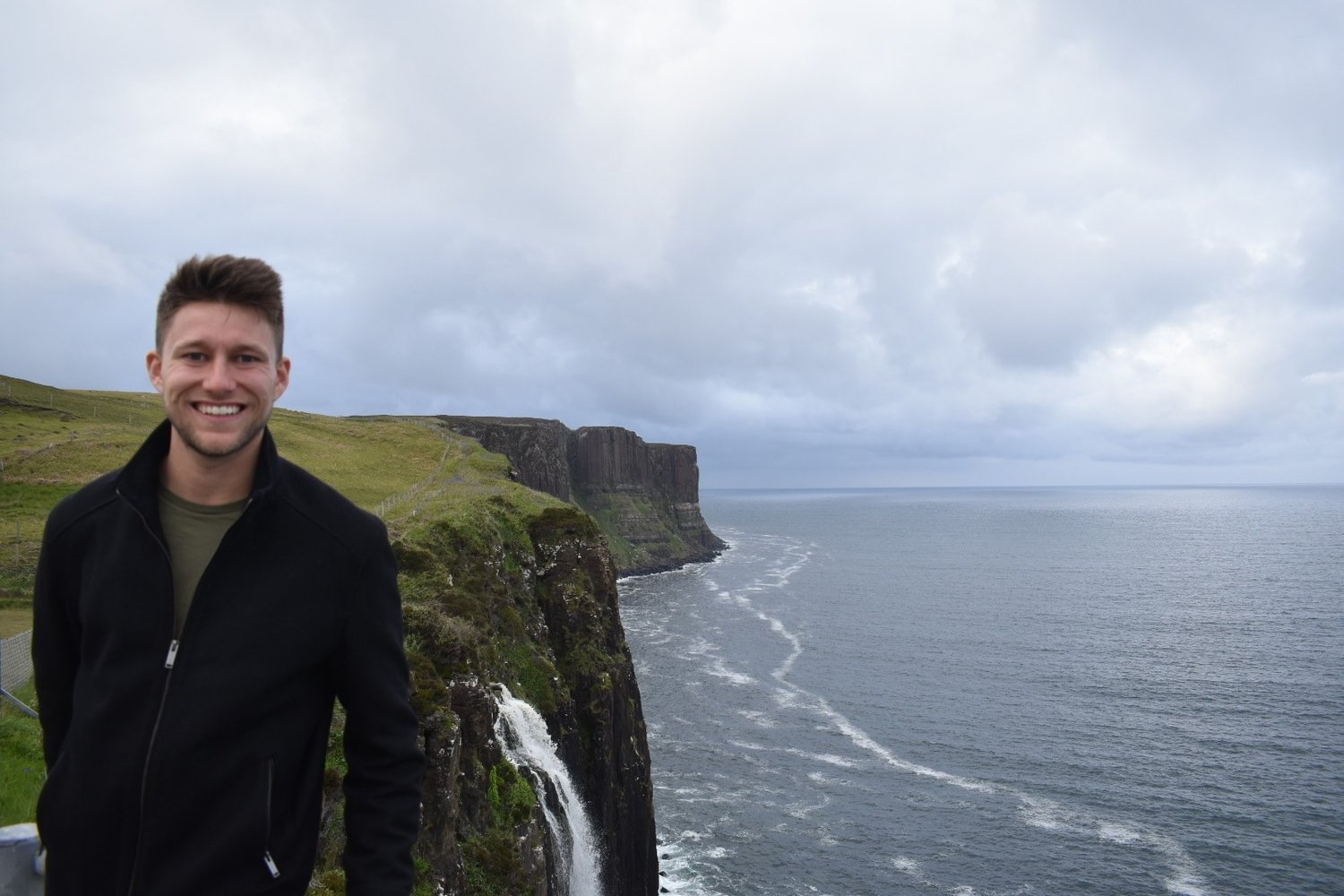 Adam on a cliff overlooking the ocean