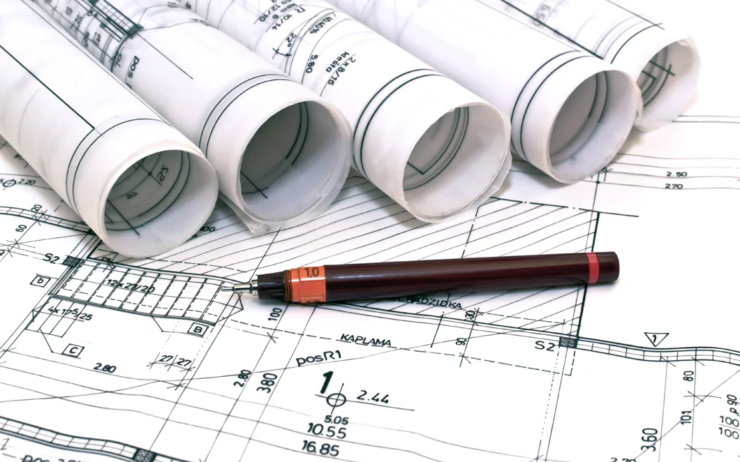 architect-drawing-rolls-and-pl-42281902.jpg