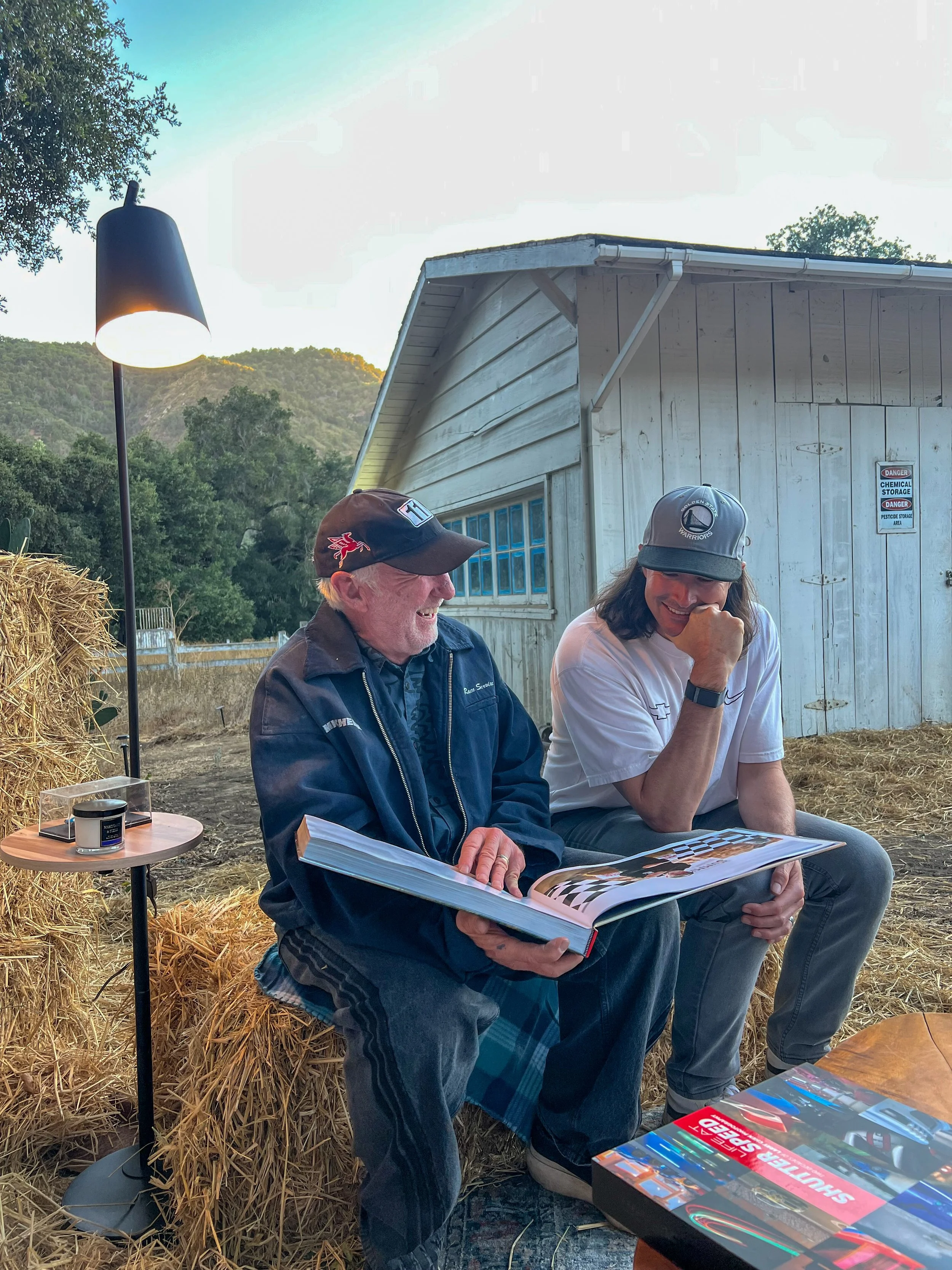 Larry Chen book 'Life At Shutter Speed' with photographer Jeff Zwart and racing driver J.R. Hildebrand at Sportscar Vacationland during Monterey Car Week 2025.