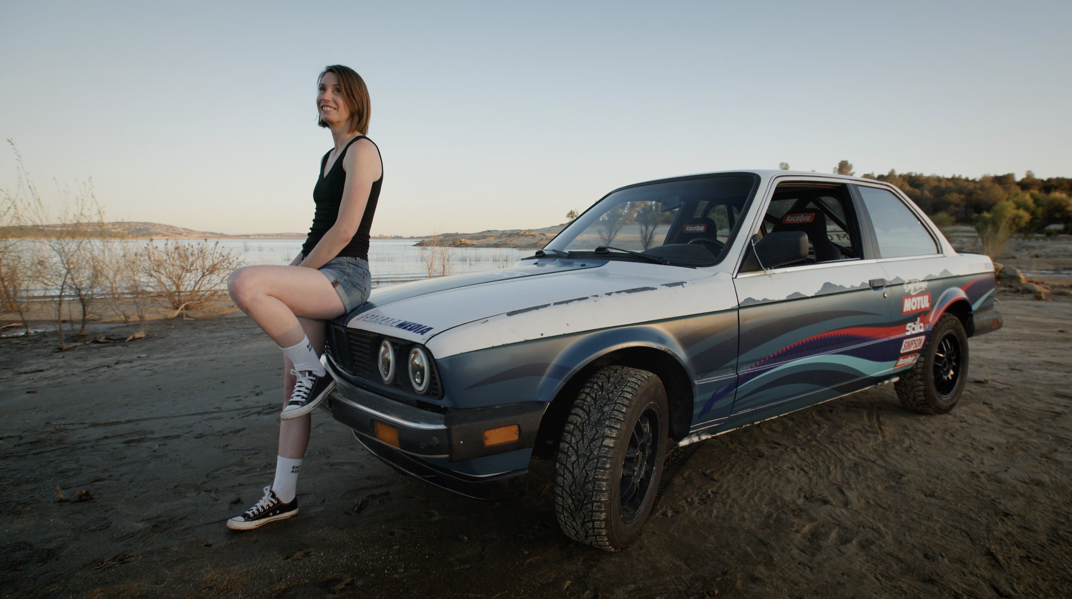 Kelly Conroy, author of the book 'Your Mom Races Rally,' poses with her BMW E30 racecar named Nessie that she learned to build and race in an effort to reinfect fun into her life as a mother. Published by Carrara Media.