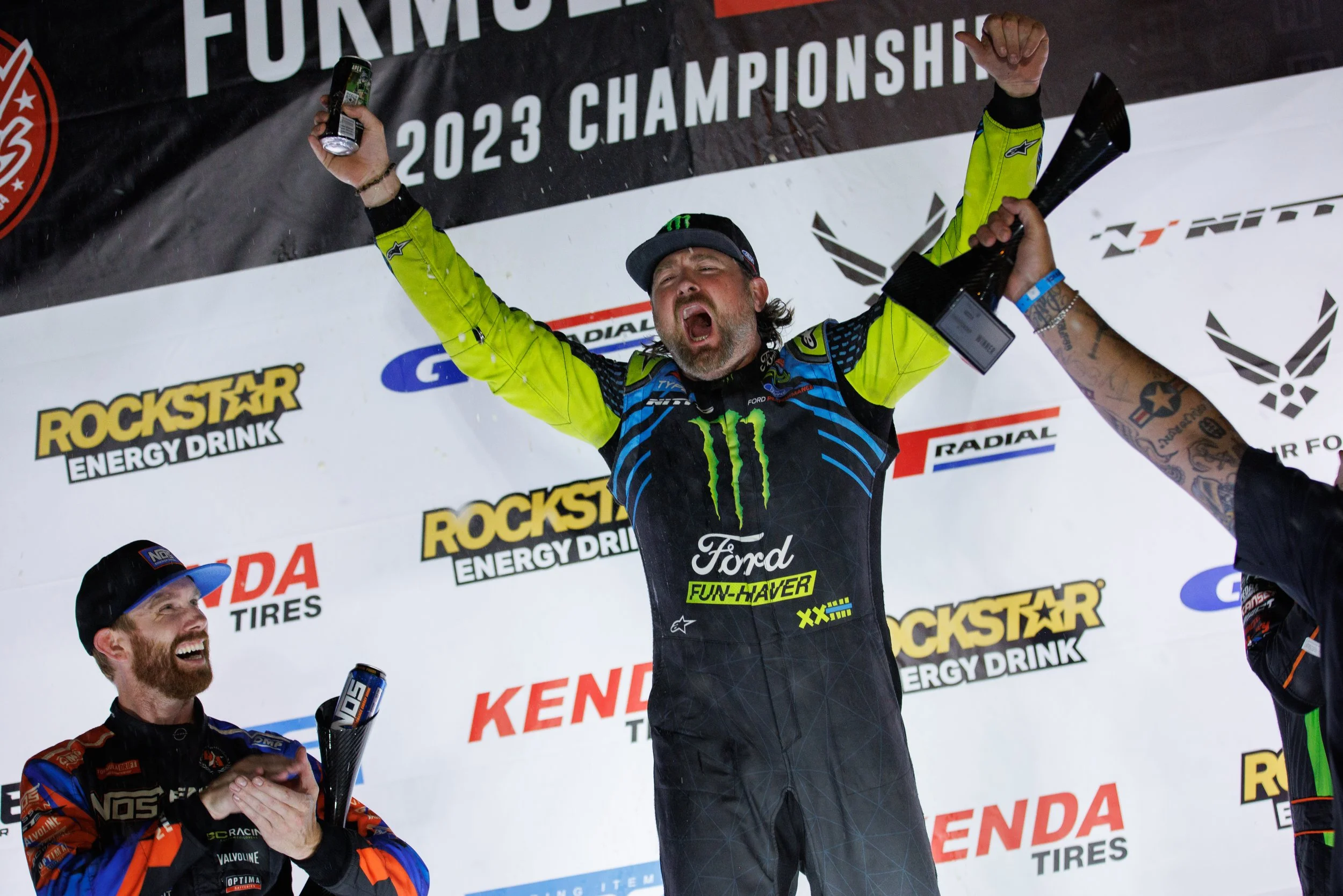 Vaughn Gittin Jr. stands atop the podium after winning a round in the 2023 Formula Drift Championship, part of his rise detailed in the book "Ready To Rock." Photo by Larry Chen. Published by Carrara Media, 2026.